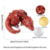 A close-up view of a natural crystal dragon figurine made of red crystal fragments bonded together with resin.