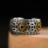 Silver and gold pixiu ring featuring detailed coin designs on the band