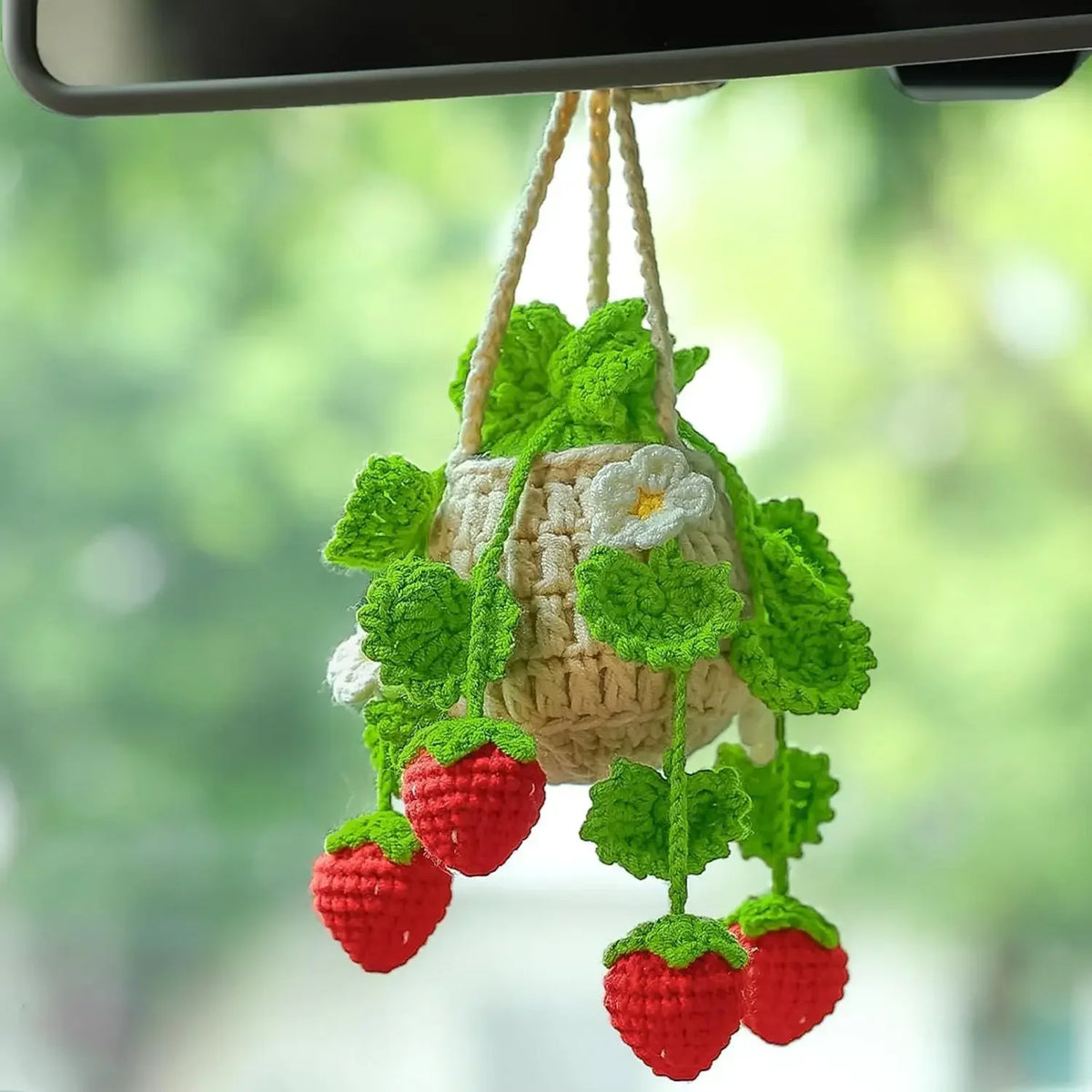 Hand-knitted hanging plant basket with green leaves and red strawberries for car mirror decor