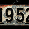 A vintage aluminum license plate with the year 1952 embossed on it, showing signs of wear and rust.