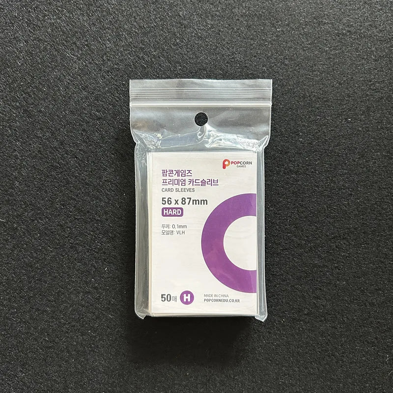 A clear plastic package containing 50 hard card sleeves for trading cards.