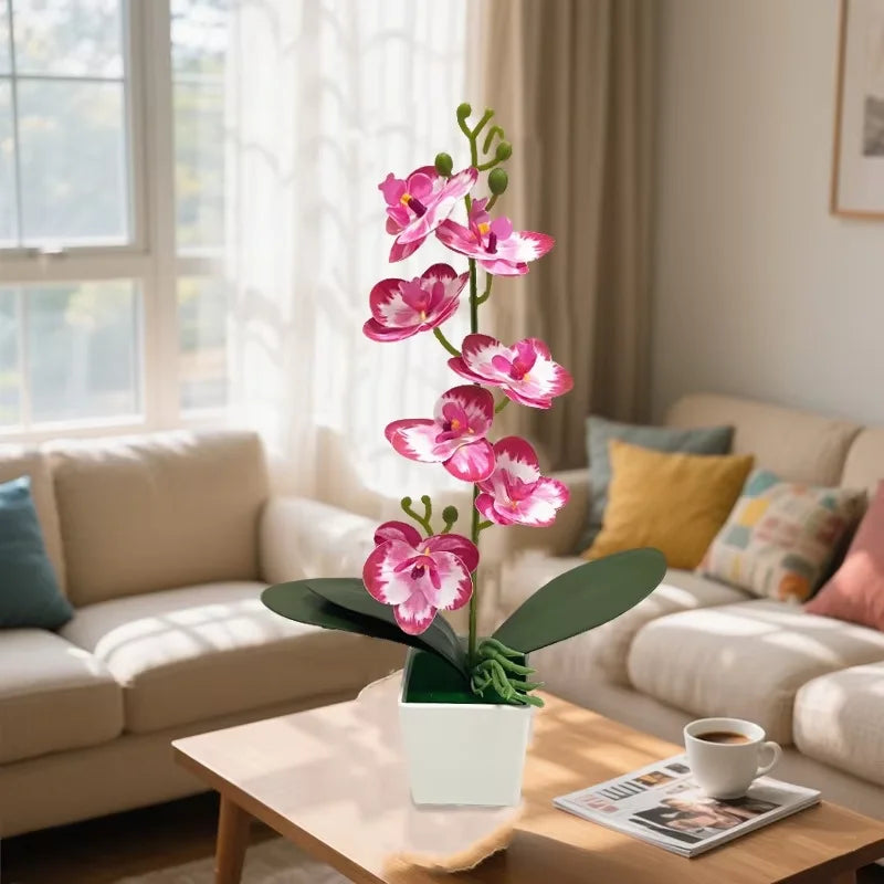 Mini artificial eucalyptus potted plant in a white ceramic pot on a wooden table
