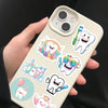 A hand holds a phone displaying various cartoon tooth fairy stickers on the back cover.