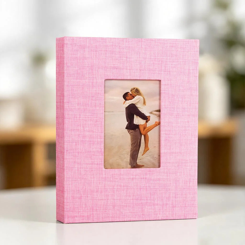 Pink linen photo album with a display window showing a couple embracing