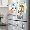 A silver refrigerator is decorated with various magnetic clips featuring family photos and text
