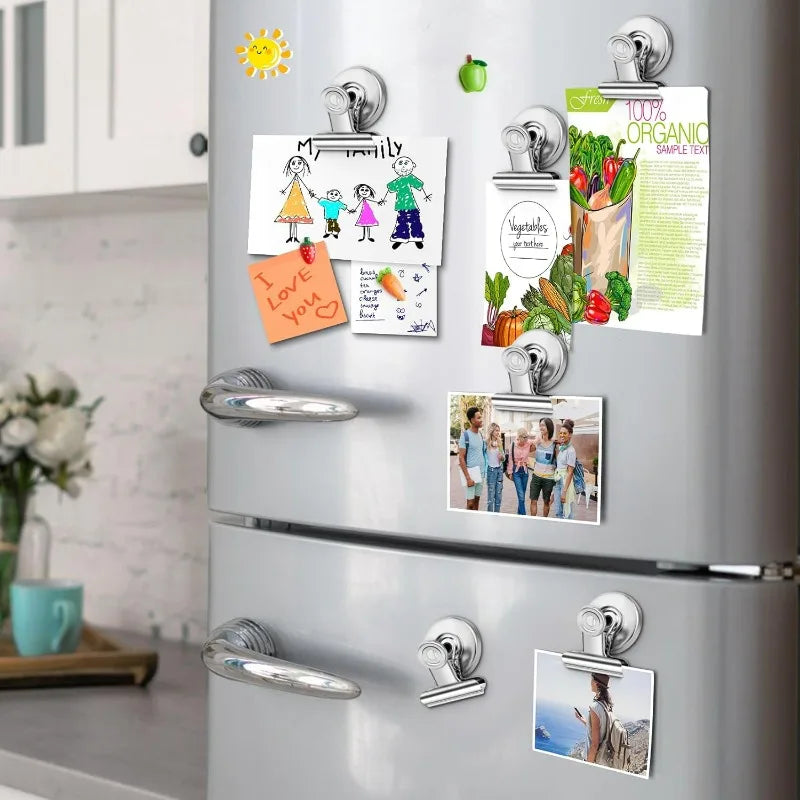 A silver refrigerator is decorated with various magnetic clips featuring family photos and text