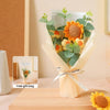 A bouquet of handcrafted crochet sunflowers and greenery wrapped in a light cream paper gift bag