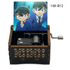 A wooden music box featuring an anime character design, likely from Detective Conan, with a metal mechanism visible inside.
