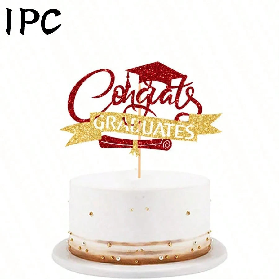A white cake with gold accents and a red glitter topper that reads Congrats Graduates
