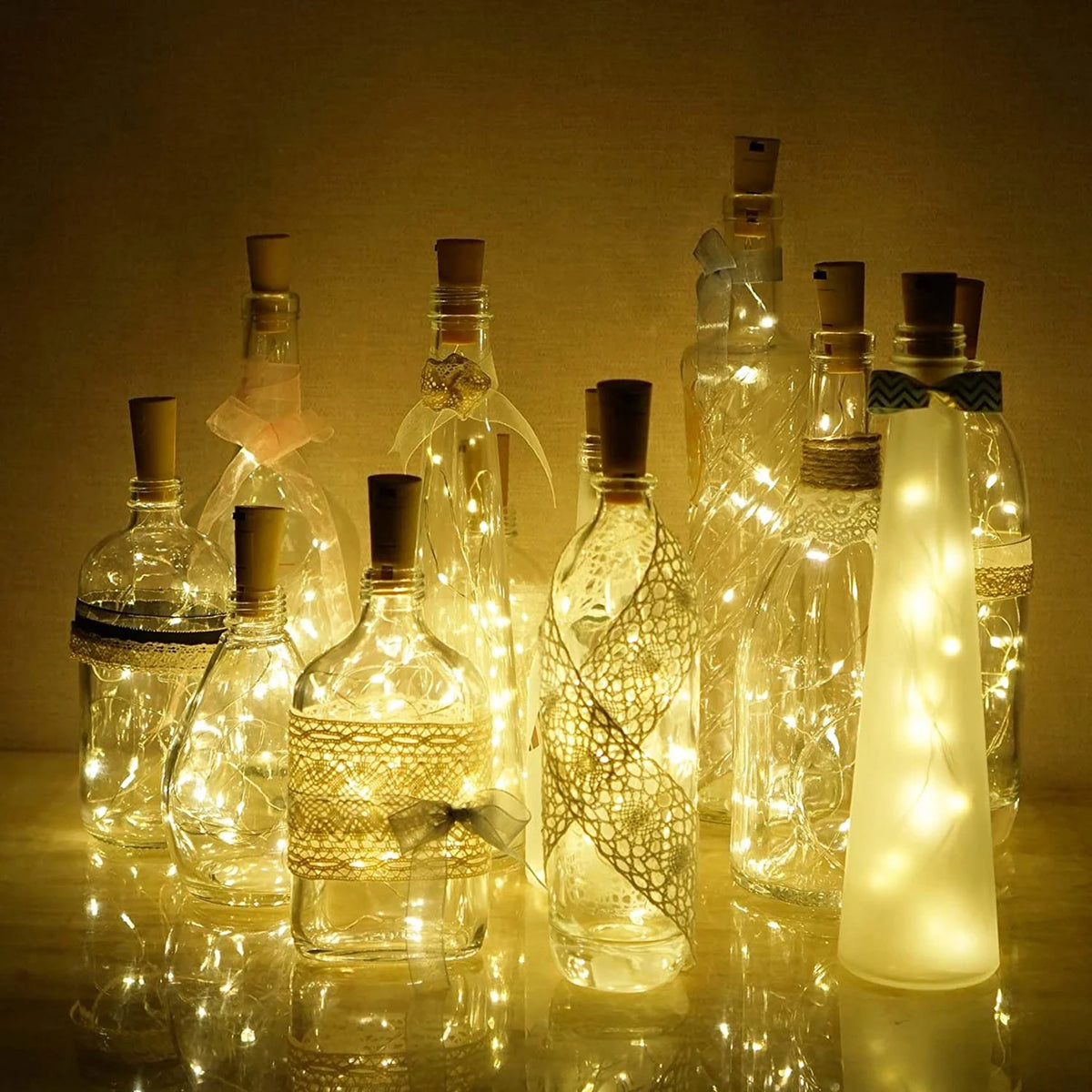 Ten glass wine bottles with LED lights inside, set against a dark background.