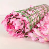 A roll of pink artificial cherry blossom privacy fence screen.