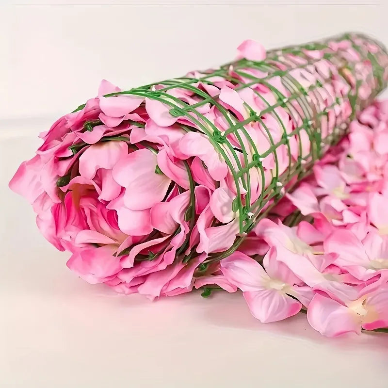 A roll of pink artificial cherry blossom privacy fence screen.
