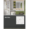 A modern bathroom or kitchen wall featuring marble-patterned decals and green cabinetry.