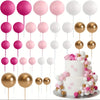 A set of 20 mini foam ball cake toppers in pink, white, and gold colors on thin sticks.