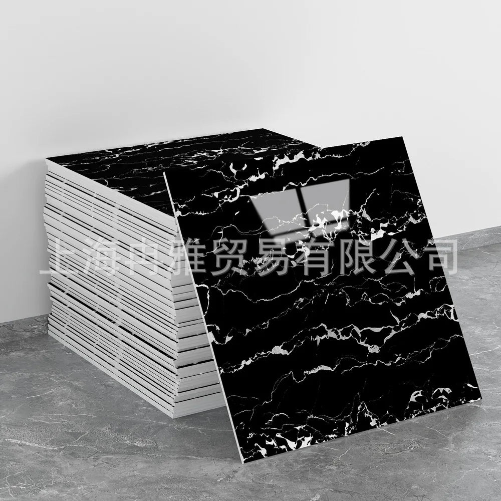 Black marble pattern faux tile sheet displayed on a gray surface.