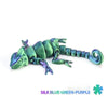 A silk blue-green-purple articulated dragon lizard figurine.