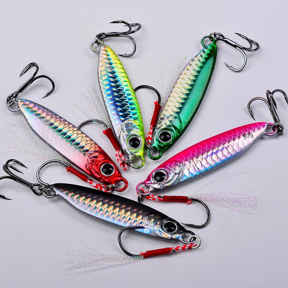 A set of five brightly colored metal jig fishing lures with hooks displayed on a white background.