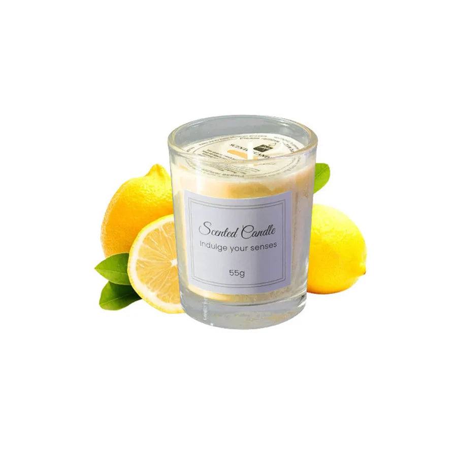 A glass jar of scented candle with a yellow wax and lemon slices beside it.