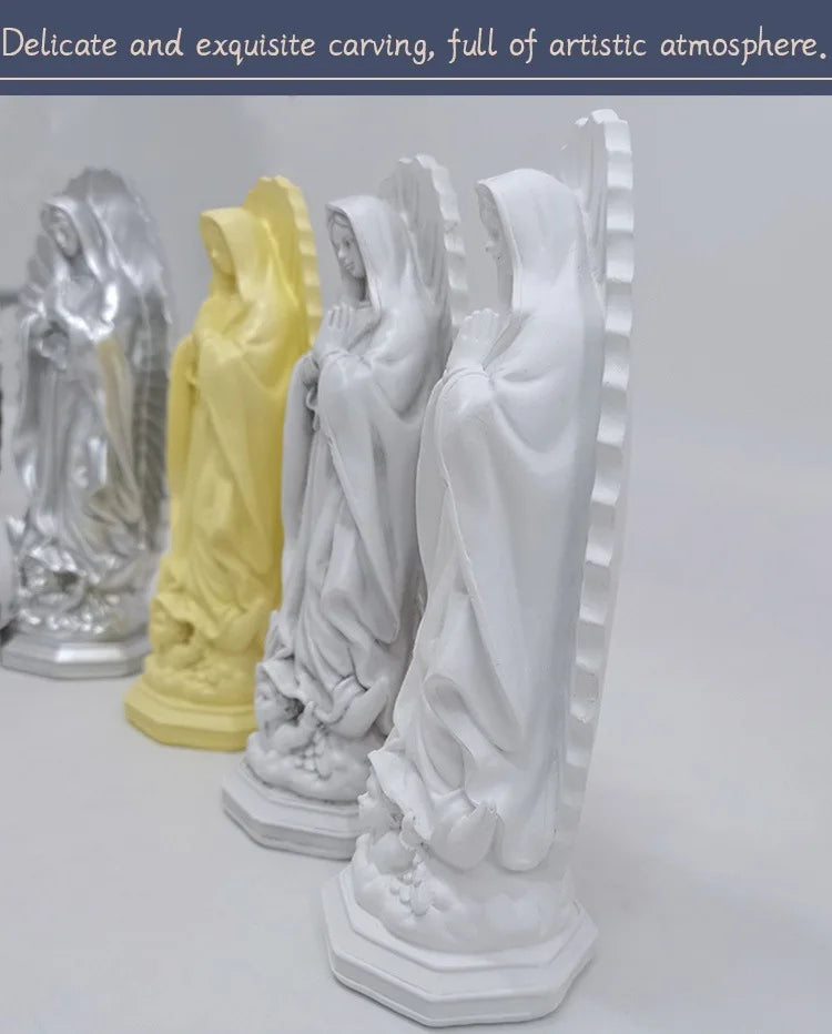 A collection of delicate and exquisite resin statues depicting Our Lady of Guadalupe in various colors.