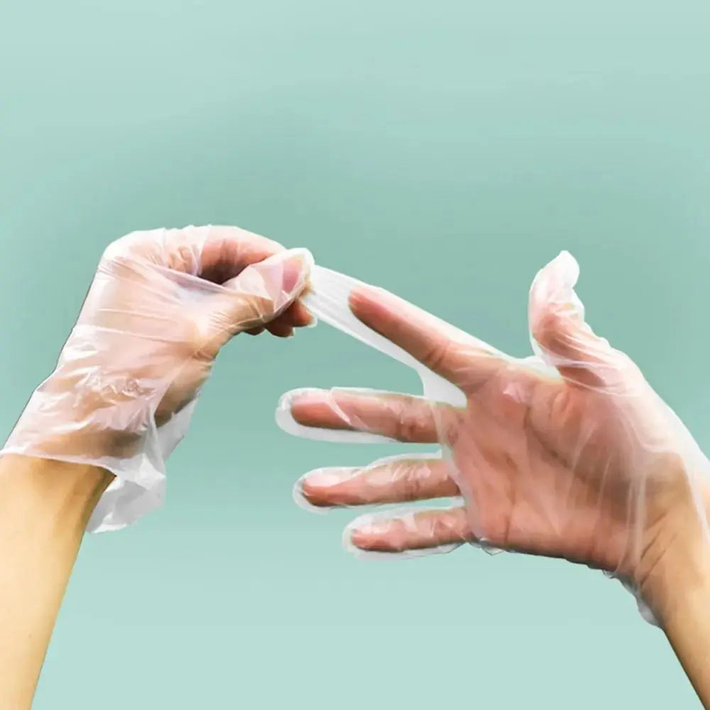 A person wearing clear disposable safety gloves is demonstrating or handling a white plastic strip.