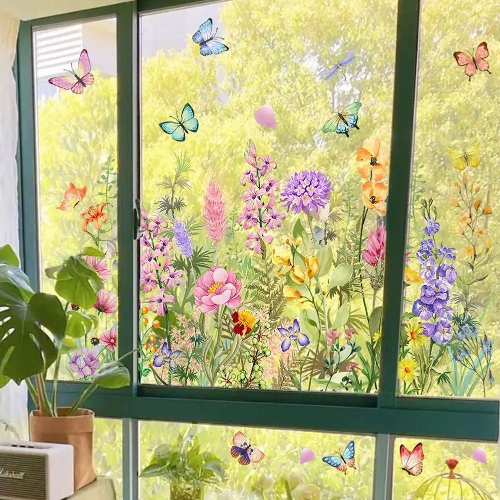 A window featuring a colorful static cling decal of butterflies and flowers against a bright green background.