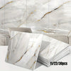 A stack of marble peel-and-stick wall panels featuring white and gold veining displayed against a background of natural marbl