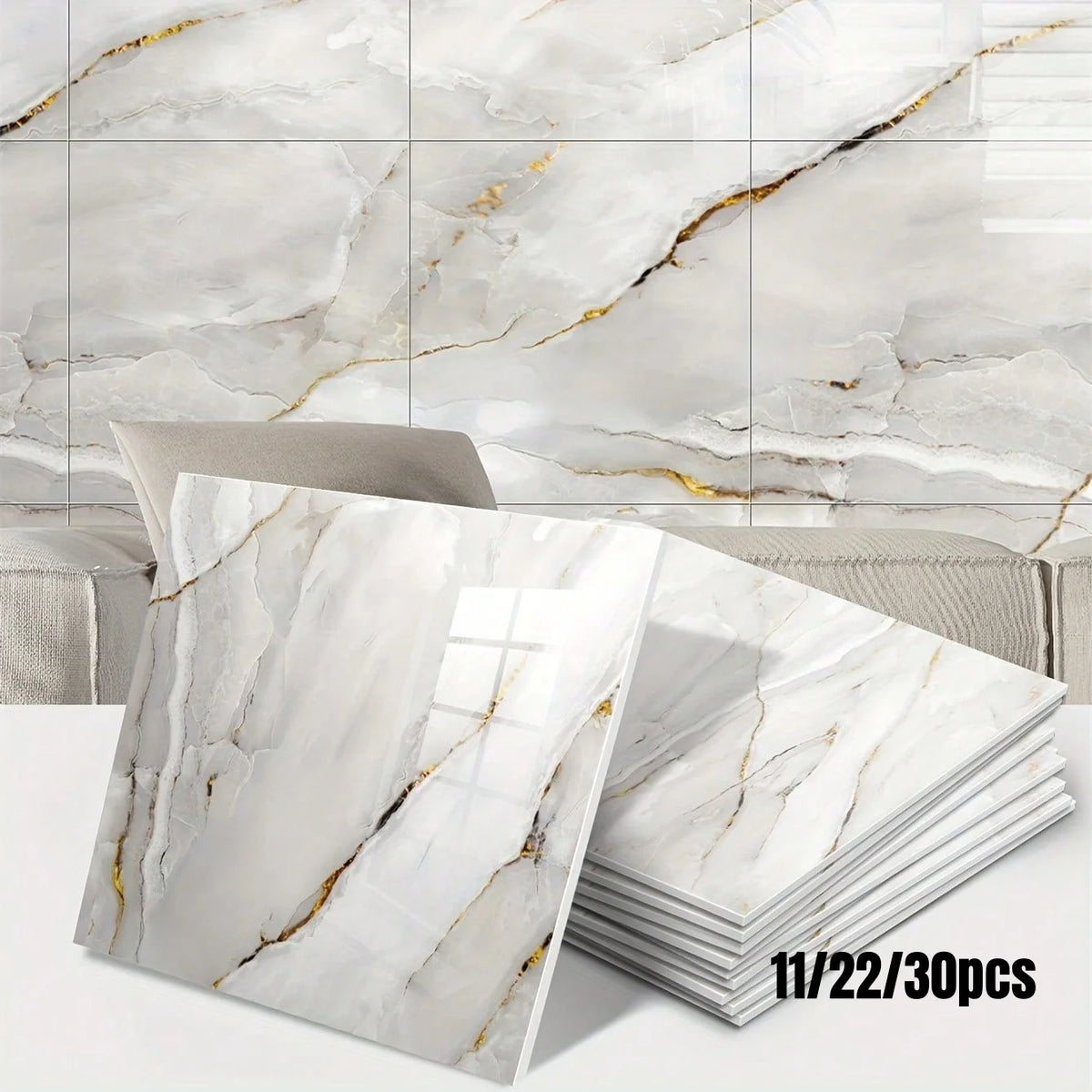 A stack of marble peel-and-stick wall panels featuring white and gold veining displayed against a background of natural marbl