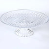 Clear acrylic serving plate with a decorative pattern on a pedestal base.