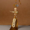 A brass gourd and five emperor coins hanging ornament with a golden thread and tassel.