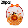 A clear bag filled with Halloween pumpkin witch treats and orange-colored decorative elements.