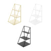 A set of three tiered iron display racks for cosmetics and jewelry in gold, white, and black finishes.