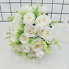 Elegant white silk rose bridal bouquet featuring creamy white roses and delicate green filler flowers