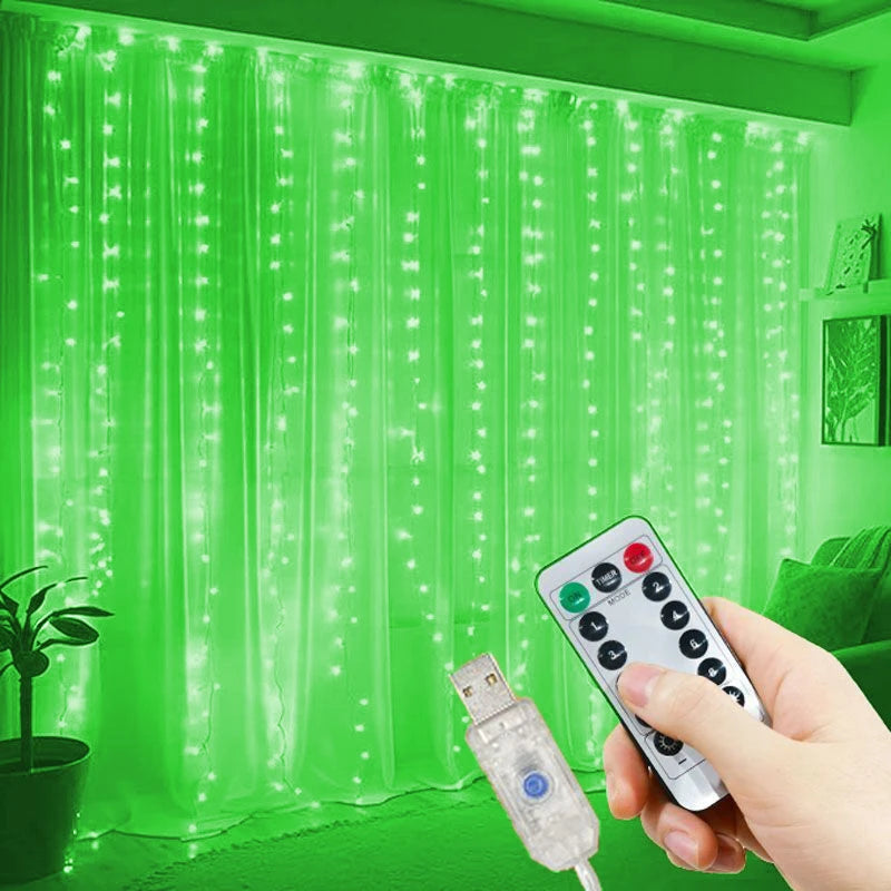 A hand holds a remote control for USB-powered LED curtain lights illuminating a sheer green curtain.