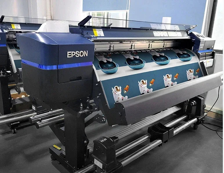 A large Epson printing machine is shown, featuring a dark blue and black design for producing basketball legends slam dunk ca