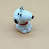 A white ceramic dog pendant with black eyes and a red collar, designed for jewelry making.
