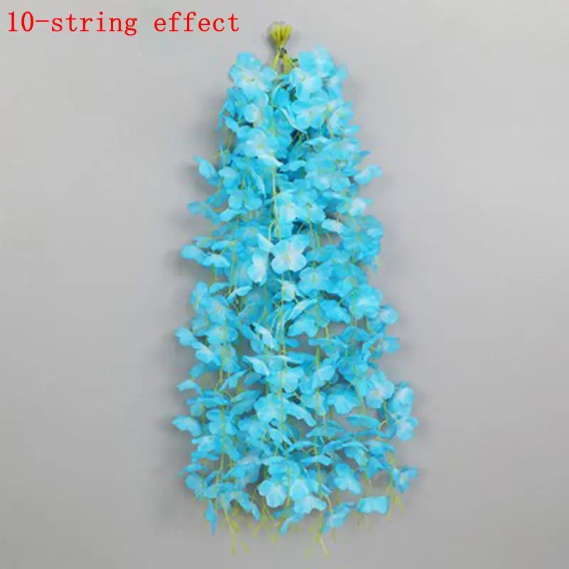 A vertical arrangement of bright blue artificial wisteria flowers forming a hanging garland.