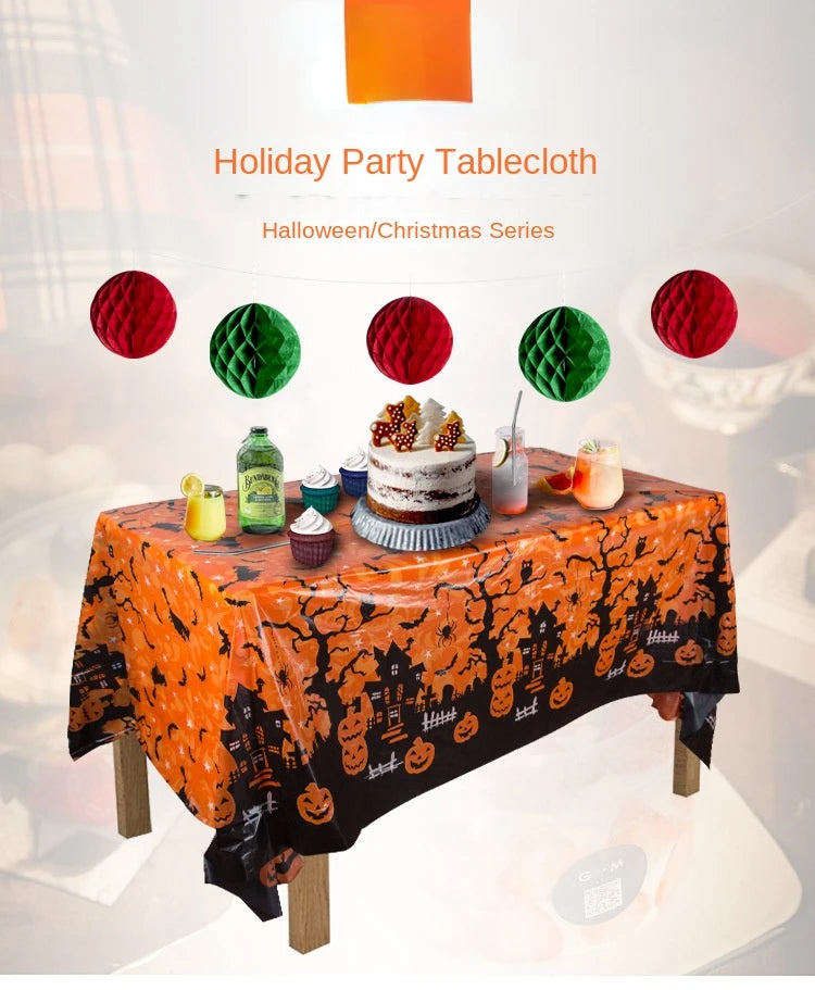 Orange Halloween tablecloth featuring a black print of pumpkins, spider webs, and bats, set for a party.