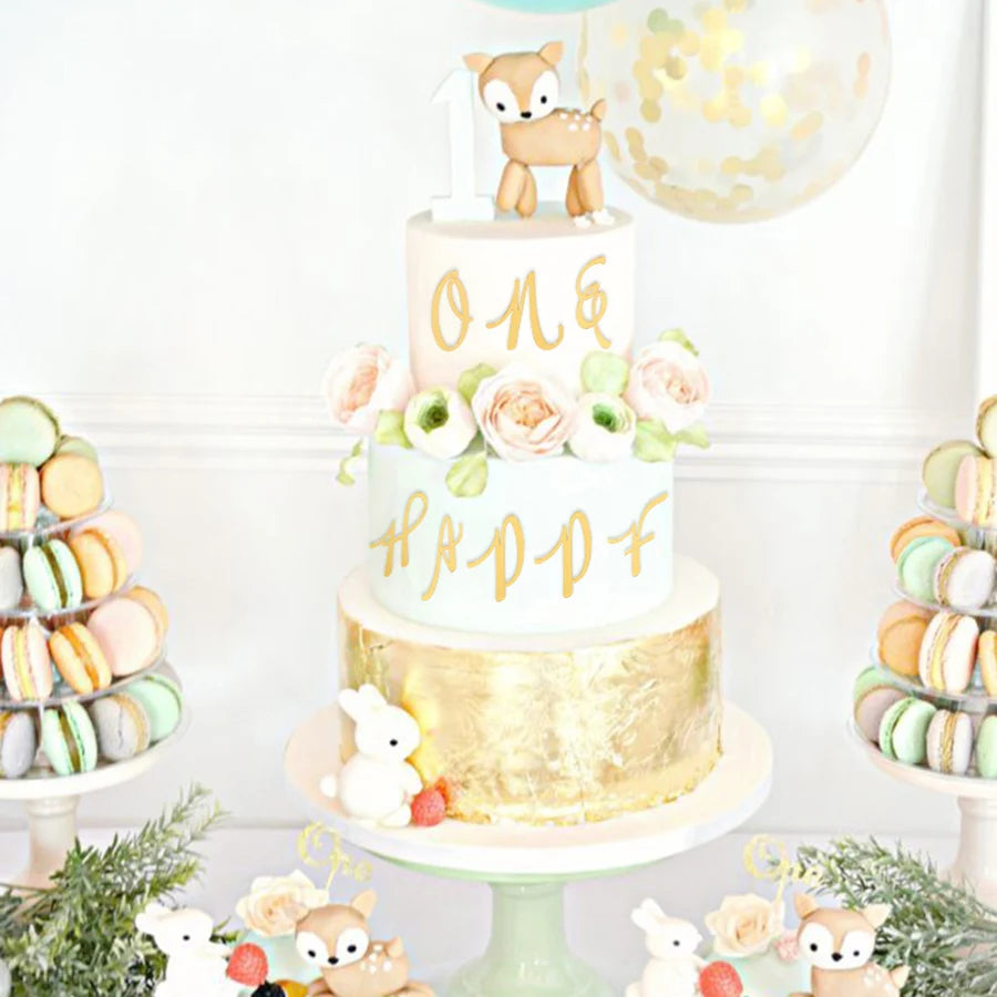 A tiered cake decorated with gold and pale green accents featuring a fox figurine and floral elements.