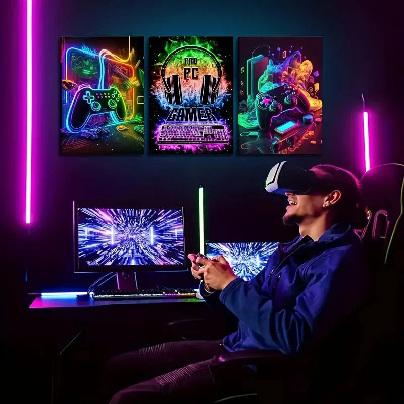 Three framed canvas prints featuring retro gaming themes and neon lighting displayed on a dark desk setup.