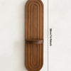 A vertical wooden wall shelf with a curved, ribbed design in a warm brown tone.