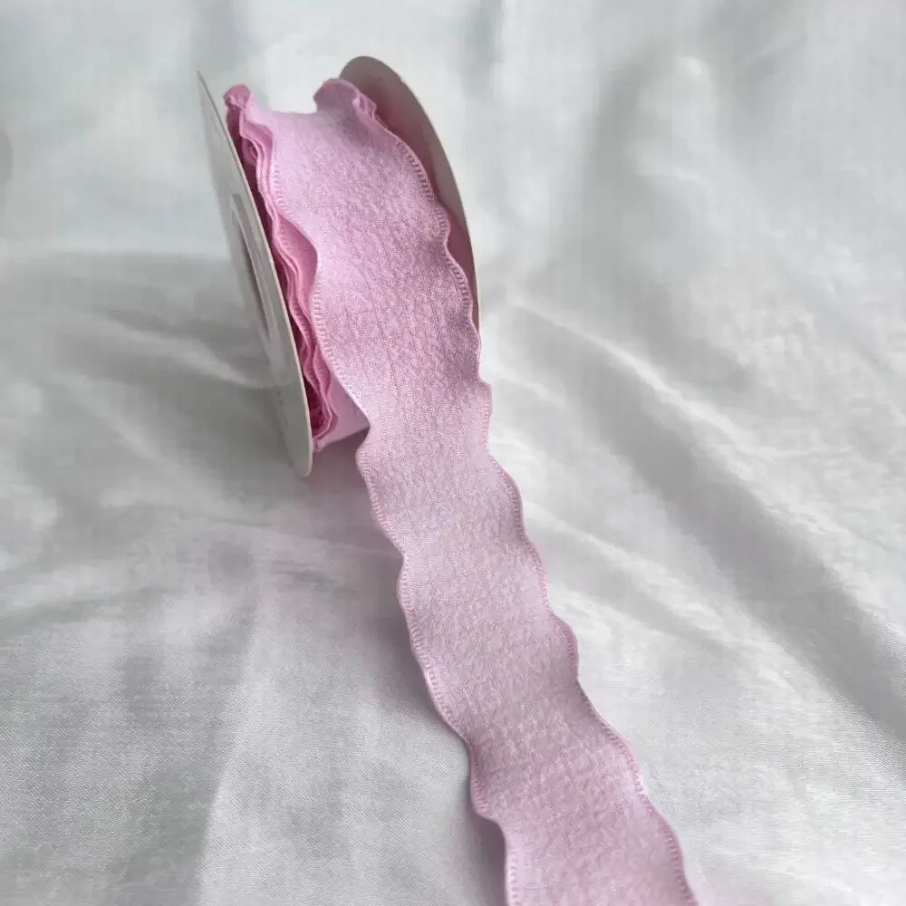Pink decorative fishtail yarn ribbon displayed on a white background.