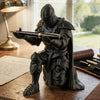 A dark metal 3D printed medieval knight figurine holding a quill pen on a wooden surface.