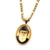 A gold-toned chain necklace with an oval pendant featuring a portrait of Saint Charbel.