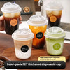 A set of clear disposable coffee cups with lids in various shades of brown and orange sitting on a wooden surface.