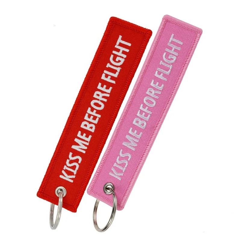 Red and pink woven flight tag keychain for a kiss me before flight theme