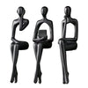 Three black abstract thinker sculptures made of modern resin for desk decor