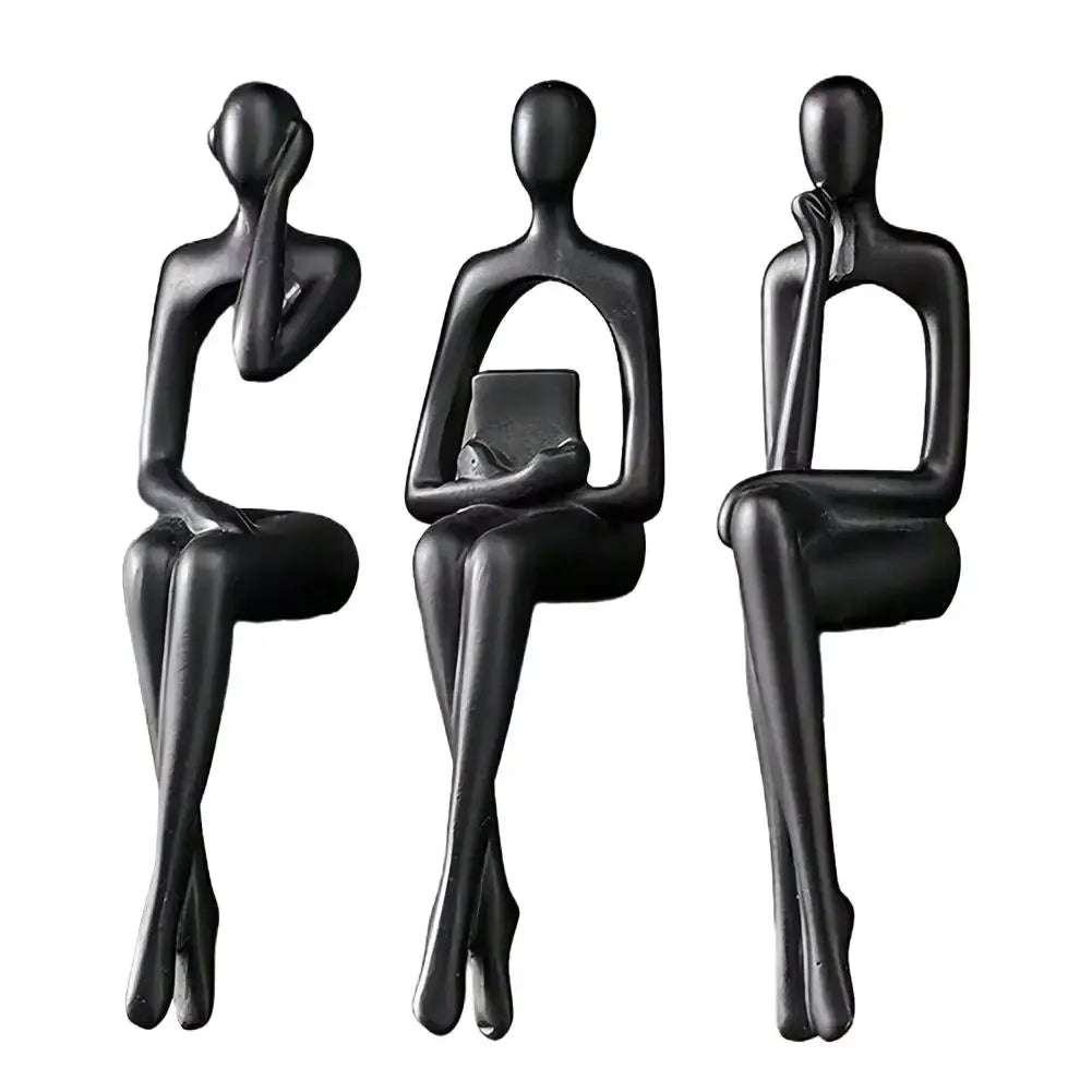 Three black abstract thinker sculptures made of modern resin for desk decor