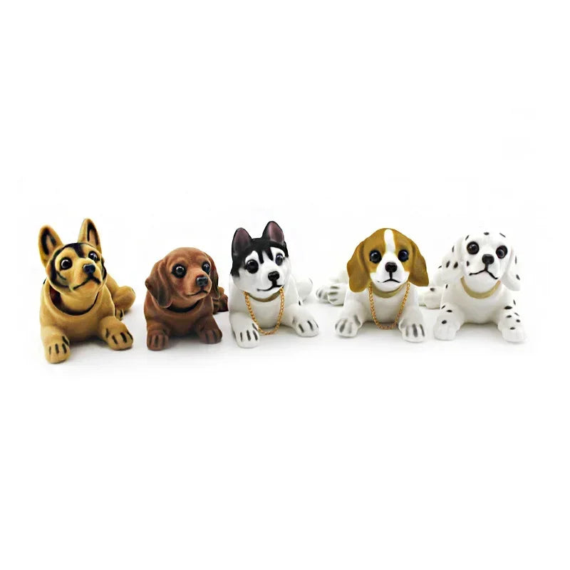 A set of five multi-figure dog ornaments, including a yellow Labrador, a brown dog, and three white and black dogs.