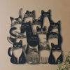 Black silhouette wall art featuring multiple cats in various poses and styles
