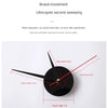 A close-up view of a black analog wall clock showing the hour hand at 9 and the second hand at 15.